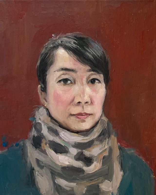 Lixia Guan - A young woman wearing a scarf